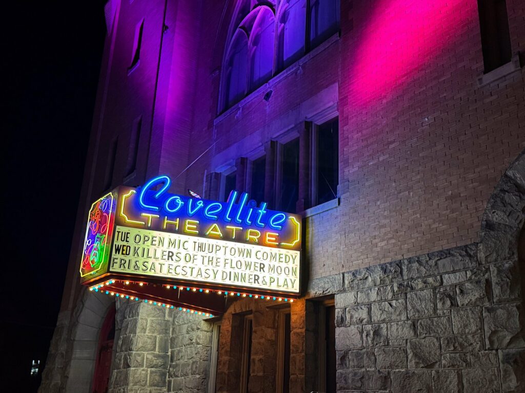 Neon lights displayed outside the Covellite Theatre in historic Uptown Butte, Montana. Colorful display against the building at night.