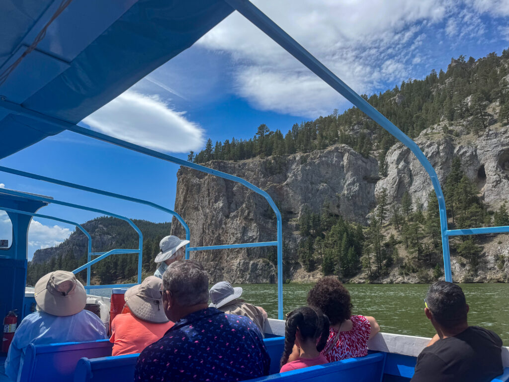 Group of people taking in the scenic views on a boat tour on the Missouri River through the Gates of the Mountains near Helena, Montana.