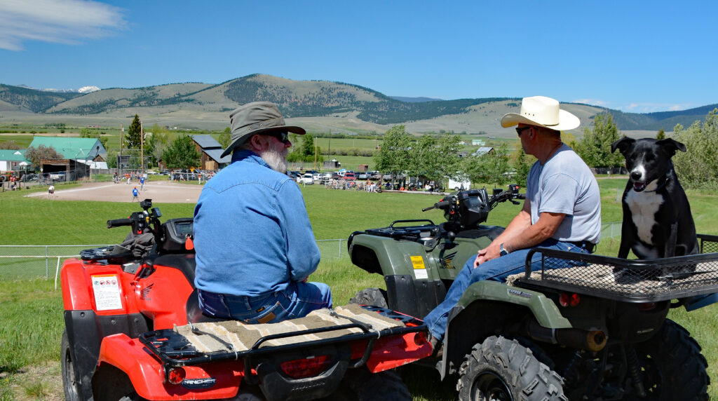 Softball Tournament in Helmville - 2 spectators on 4 wheelers