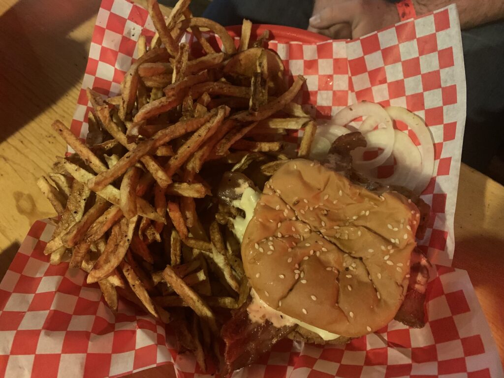 A 1/2 pound, hand pattied, fresh and never frozen burger with hand-cut fries at the Big Bull Bar in Winston, Montana. Known for its locally sourced bison burgers, a meal at the Big Bull Bar is a taste of Montana.