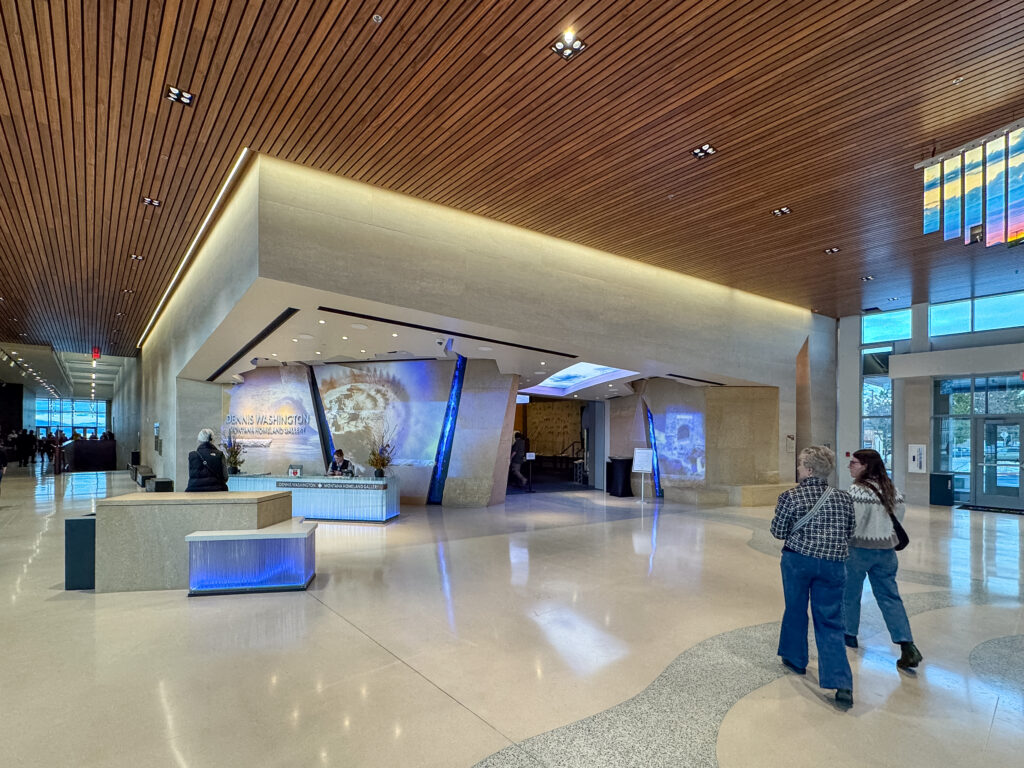 Visitors walking through the modern lobby toward the Dennis Washington Montana Homeland Gallery at the Montana Heritage Center in Helena, Montana. Photo by Sarah Bolt, Tempest Technologies.